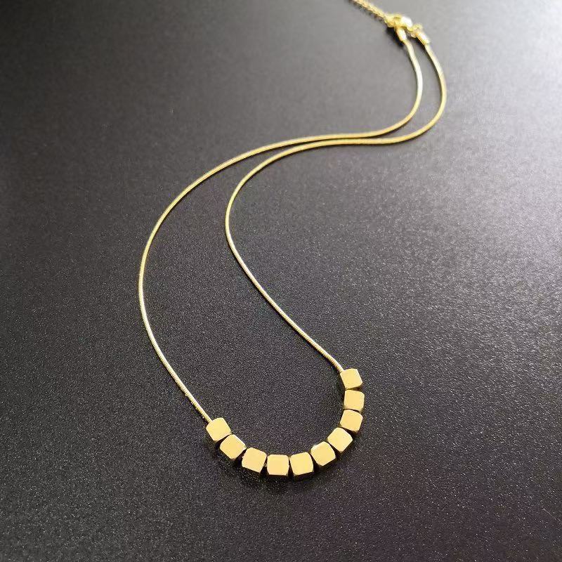 Paired with a gold small square necklace for women in the spring and summer of 2025, this is a light luxury niche design with a high-end titanium steel feel
